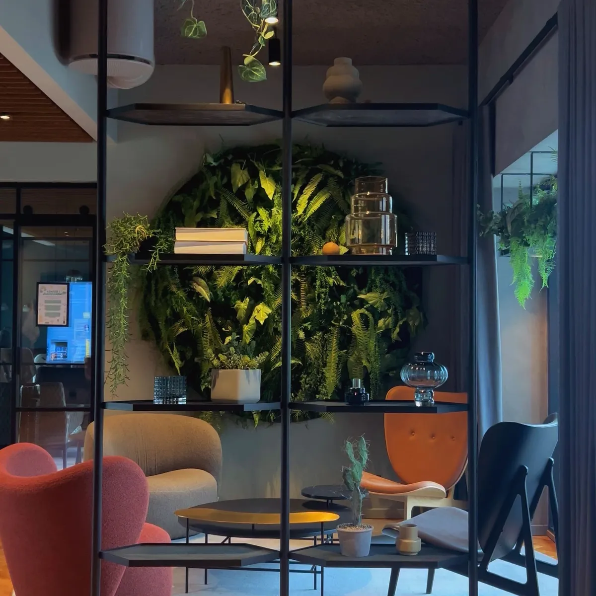 Modern office lounge with a vertical garden built into the wall
