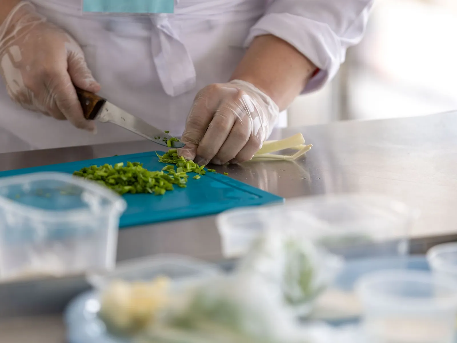 Chef preparing fresh herbs in a professional restaurant kitchen